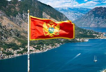 Kotor. Bay of Kotor on the background of the flag of Montenegro. Kotor fortress.
