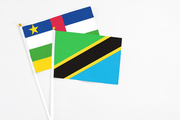Tanzania and Central African Republic stick flags on white background. High quality fabric, miniature national flag. Peaceful global concept.White floor for copy space.