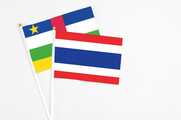 Thailand and Central African Republic stick flags on white background. High quality fabric, miniature national flag. Peaceful global concept.White floor for copy space.