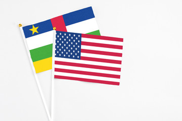 United States and Central African Republic stick flags on white background. High quality fabric, miniature national flag. Peaceful global concept.White floor for copy space.