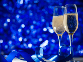 Glasses of champagne on a festive blue background copy space © pavelkant