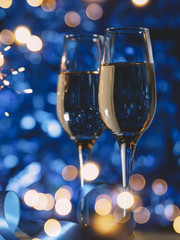 Christmas decorations before Christmas party . Two glasses of champagne on a festive background