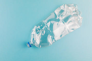 Crumpled plastic bottles on a blue background. Plastic trash.