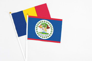 Belize and Chad stick flags on white background. High quality fabric, miniature national flag. Peaceful global concept.White floor for copy space.