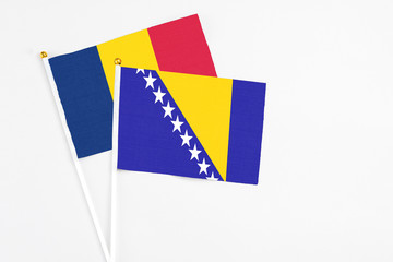 Bosnia Herzegovina and Chad stick flags on white background. High quality fabric, miniature...