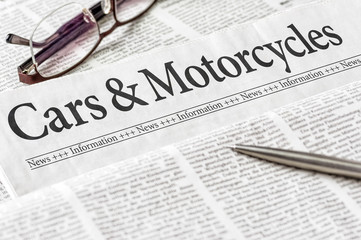 A newspaper with the headline Cars and Motorcycles