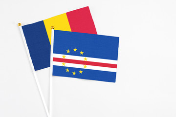 Cape Verde and Chad stick flags on white background. High quality fabric, miniature national flag. Peaceful global concept.White floor for copy space.