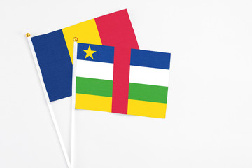 Central African Republic and Chad stick flags on white background. High quality fabric, miniature national flag. Peaceful global concept.White floor for copy space.