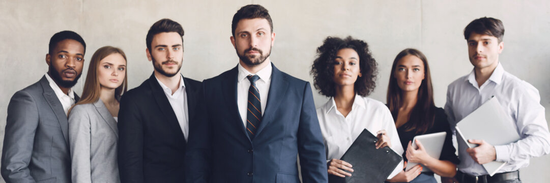 Business team headed with boss, posing to camera