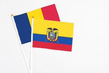 Fototapeta premium Ecuador and Chad stick flags on white background. High quality fabric, miniature national flag. Peaceful global concept.White floor for copy space.