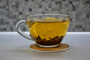 Cup of black tea with lemon on table close-up