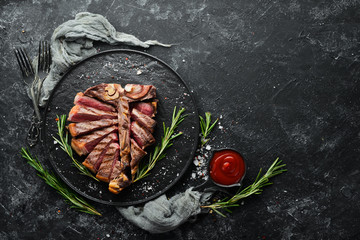 Sliced roast veal steak with rosemary and spices. Top view. Free space for your text.