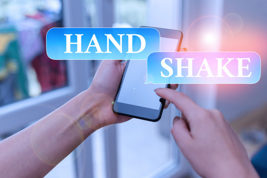 Text sign showing Hand Shake. Business photo text an act showing that you have made an agreement or greeting woman using smartphone office supplies technological devices inside home