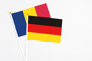 Germany and Chad stick flags on white background. High quality fabric, miniature national flag. Peaceful global concept.White floor for copy space.