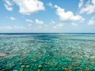 Low aerial over Norman Reef looking toward the horizon in the GBR, Australia