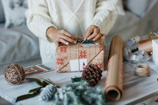 woman hands wrapping presents for christmas