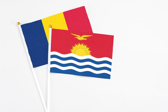 Kiribati and Chad stick flags on white background. High quality fabric, miniature national flag. Peaceful global concept.White floor for copy space.