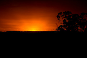 Vibrant red sunset caused by bushfire smoke and dust in the blue mountains in australia
