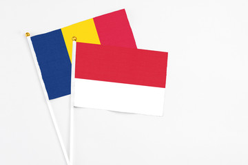 Monaco and Chad stick flags on white background. High quality fabric, miniature national flag. Peaceful global concept.White floor for copy space.