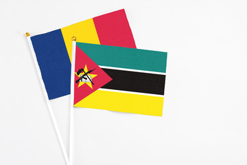 Mozambique and Chad stick flags on white background. High quality fabric, miniature national flag. Peaceful global concept.White floor for copy space.