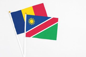Namibia and Chad stick flags on white background. High quality fabric, miniature national flag. Peaceful global concept.White floor for copy space.