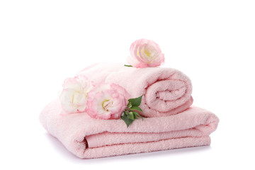 Obraz na płótnie Canvas Pink towels and flowers isolated on white background