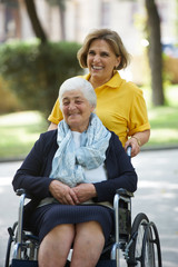 Careful caregiver taking care of the patient, outdoors.
