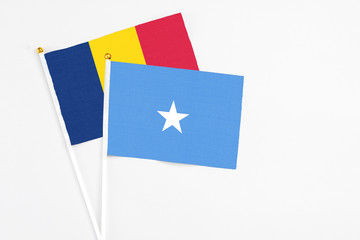 Somalia and Chad stick flags on white background. High quality fabric, miniature national flag. Peaceful global concept.White floor for copy space.