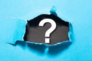 Question mark and broken paper. Creative concept.