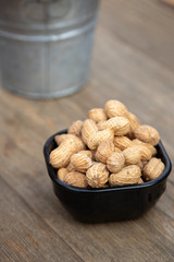 Bowl of peanuts on a wood bar counter