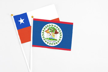 Belize and Chile stick flags on white background. High quality fabric, miniature national flag. Peaceful global concept.White floor for copy space.