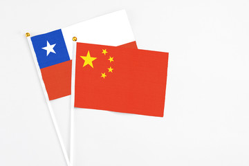 China and Chile stick flags on white background. High quality fabric, miniature national flag. Peaceful global concept.White floor for copy space.