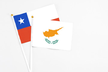 Cyprus and Chile stick flags on white background. High quality fabric, miniature national flag. Peaceful global concept.White floor for copy space.