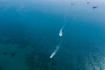 People are playing a jet ski in the sea.Aerial view. Top view.amazing nature background.