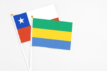 Gabon and Chile stick flags on white background. High quality fabric, miniature national flag....