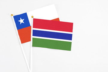 Gambia and Chile stick flags on white background. High quality fabric, miniature national flag. Peaceful global concept.White floor for copy space.