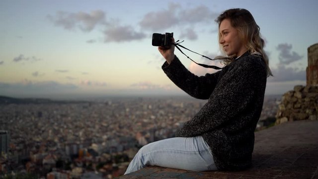 Portrait of female photographer with city in background