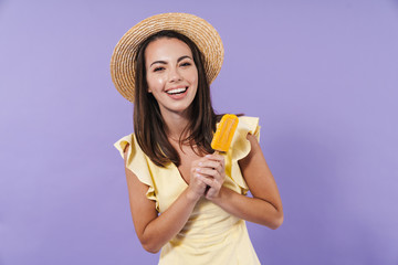 Cheerful pretty girl wearing summer dress and straw hat
