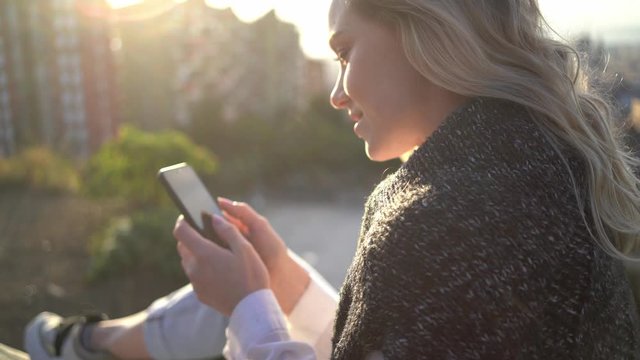 Woman writing text message on smartphone
