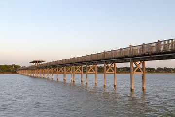 Fototapeta na wymiar wooden walkway bridge over river