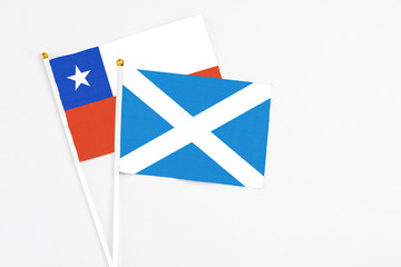 Scotland and Chile stick flags on white background. High quality fabric, miniature national flag. Peaceful global concept.White floor for copy space.