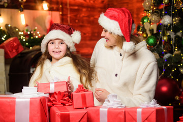 Obraz na płótnie Canvas Tis the season to be Jolly. merry christmas. mother and daughter love holidays. small child girl with mom in santa hat. xmas gift boxes. Open present. Happy family celebrate new year