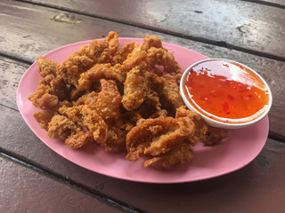 deep fried skin chicken on plate with sauce