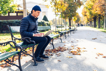 Young man in a cap on a bench