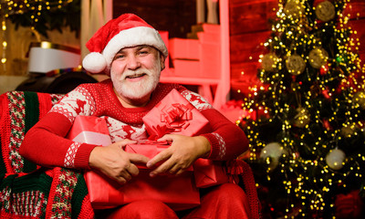 Santa Claus relaxing in arm chair. Delivering gifts. Winter vacation. Traditions concept. Santa Claus near christmas tree. Bearded senior man Santa Claus. Merry christmas. Elderly grandpa at home