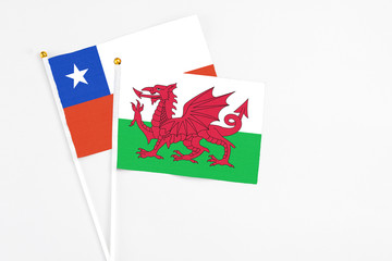 Wales and Chile stick flags on white background. High quality fabric, miniature national flag. Peaceful global concept.White floor for copy space.