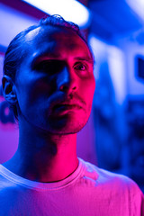 Modern red and blue light portrait of a young man