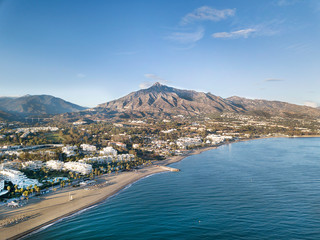 Beautiful aerial Panoramic View of Marbella, Nueva Andalucia and Puerto Banus area. Beautiful colours at sunset. La Concha mountain in background.  - obrazy, fototapety, plakaty