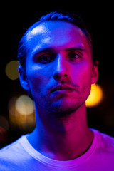 Modern red and blue light portrait of a young man