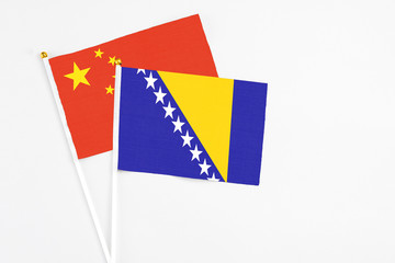 Bosnia Herzegovina and China stick flags on white background. High quality fabric, miniature...